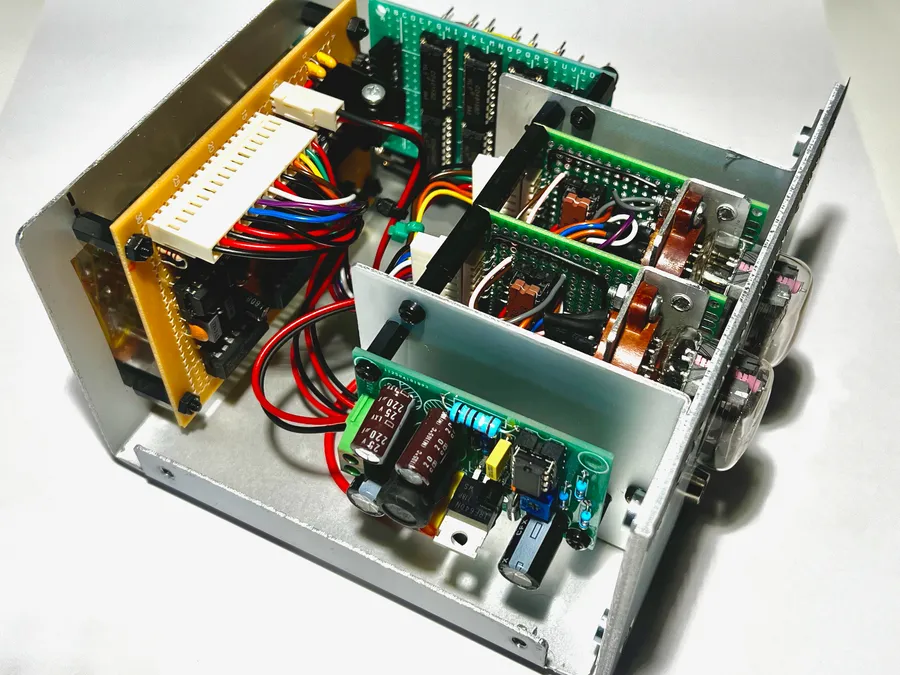Click to view full size - The nearest board is the high voltage supply for the Nixies. The beige board at the back contains the 555 timers and latches.